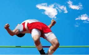Athlete leaping backward over a high jump bar
